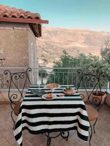 a table with plates of food on a balcony at Villa Maria Mountain View in Himare