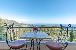a table and two chairs on a balcony with the ocean at Villa Maria Mountain View in Himare