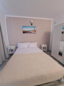 En eller flere senge i et værelse på Vila Karen