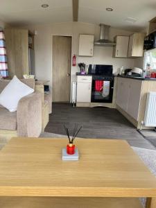 a kitchen and a living room with a table in a room at 32 Elm Walk in Whitley Bay