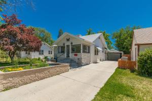 a white house with a driveway in a yard at Butterfly - Cozy Downtown Cottage Peaceful Backyard! in Grand Junction