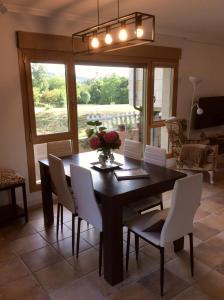 a dining room with a table and white chairs at Puente Romano in Galizano +32 photos