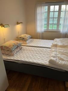 A bed or beds in a room at Trunna Vandrarhem & Konferens