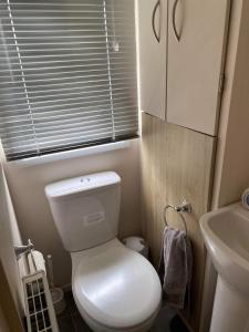 a small bathroom with a toilet and a sink at 32 Elm Walk in Whitley Bay
