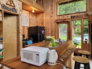 a kitchen with a microwave on a wooden counter at Rustic cedar Cabin in Powell River