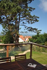 a table and chairs on a balcony with a view at La Source - Villa wissantaise in Wissant
