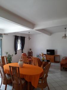 a dining room with a table and chairs at Chez Lucile et Gilbert in Bouillante