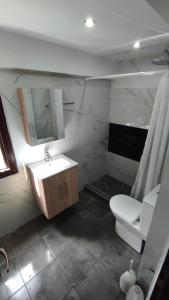 a bathroom with a sink and a toilet and a mirror at Villa Miranda in Nikiti
