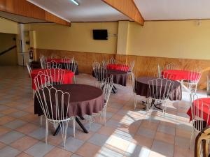 a conference room with tables and chairs and a tv at HOTEL ASTORE Matta 2537 in Antofagasta