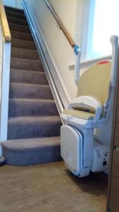 a hospital room with a chair sitting next to a staircase at Beeston House in Thornton