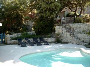 a swimming pool with lounge chairs next to a yard at PROVENCE SOLEIL LUBERON PISCINE in Apt +6 photos