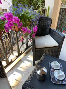 eine Terrasse mit einem Tisch, einem Stuhl und Blumen in der Unterkunft Andrew’s House in Ortona