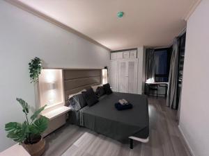 a bedroom with a bed and a table in a room at Luxury Apartment with pool view in Adeje