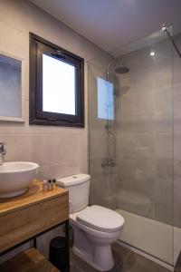 a bathroom with a toilet and a sink and a shower at Zoi Ayia Napa in Ayia Napa
