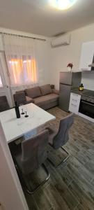 a kitchen and living room with a table and chairs at Lavanda in Vrana