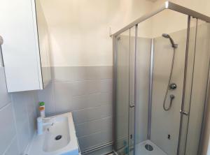 a bathroom with a shower and a sink at Les lumières du phare in Calais +9 photos