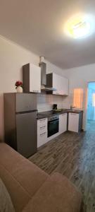 a kitchen with white appliances and a wooden floor at Lavanda in Vrana