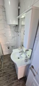 a white bathroom with a sink and a mirror at Lavanda in Vrana