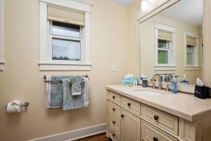 a bathroom with a sink and a mirror at Santos Family Farm Retreat in Yamhill +31 photos
