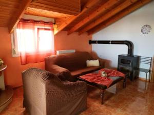 a living room with a couch and a stove at Noufara Apartments in Nea Mesangala