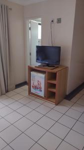 a television sitting on a stand in a room at diRoma Fiore Hoteis Caldas Novas e os melhores Parques, Acqua Park, Splash, Slide in Caldas Novas
