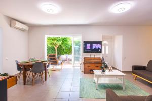a living room with a couch and a table at VILLA PROVENCE-SPA&BBQ CENTRE AU CALME- JARDIN - TERRASSES in La Valette-du-Var