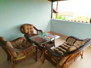 a living room with chairs and a coffee table at Noufara Apartments in Nea Mesangala