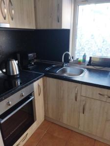 a kitchen with a sink and a counter top at Burgas Central-Sheynovo in Burgas City