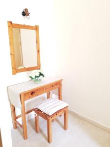 a dressing table with a bench and a mirror at Corfu Escape Five ( Leonidas Studios) in Agios Georgios Pagon