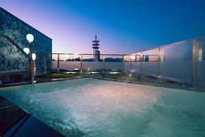 a swimming pool on the roof of a building at Hotel Grand View Takasaki in Takasaki