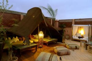 un patio en la azotea con cenador y sofá en Riad Palacio De Las Especias, en Marrakech