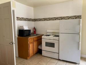 a kitchen with a white stove and a refrigerator at Offshore Motel in Seaside Heights