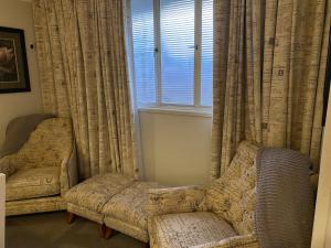 a living room with a chair and a window at Freshwater BnB in Hervey Bay