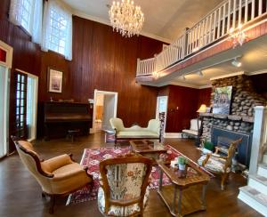 a living room with a table and a fireplace at heritage style cottage by the lake in Orillia