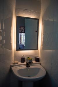 a bathroom with a sink and a mirror at GreenHouse EcoLodge in Mantanani Island 