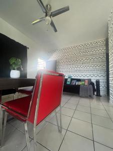 a red chair in a living room with a ceiling fan at New Best Deal 2 Bedroom Apartment in Bayamon, By RentalsPR in Bayamon +21 photos