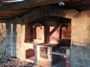 a brick oven with a shadow on the wall at Domek Stojkowo in Stojkowo