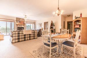 a dining room and living room with a table and chairs at Condo with Stunning Mountain and 6th Green views near Harrahs Cherokee Bryson City in Whittier