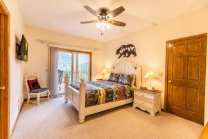 a bedroom with a bed and a ceiling fan at Condo with Stunning Mountain and 6th Green views near Harrahs Cherokee Bryson City in Whittier +17 photos