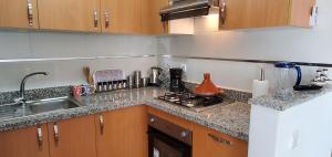 a kitchen with a sink and a counter top at Asilah Marina Golf in Asilah