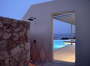 a room with a door leading to a swimming pool at Yoma Cove Suites in Volímai