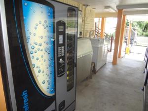 a vending machine in a room with a kitchen at Antlers Inn Goliad in Goliad