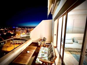 a balcony with a view of a city at night at OceanParc - Vue sur Mer et Parc 24H Sécurité in Mohammedia