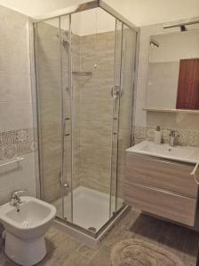 a bathroom with a shower and a toilet and a sink at Casa nella Natura Il Risveglio degli Elfi in Pedavena