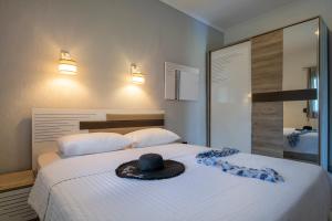 a bedroom with a bed with a hat on it at Exochiko Kalamitsi in Kalamitsi