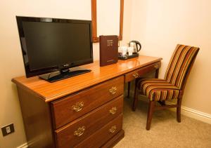 a desk with a chair and a tv at Drury Court Hotel in Dublin
