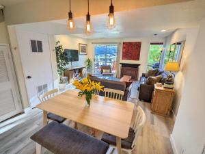 a dining room and living room with a table and chairs at Old Town Views Just Steps to Main Street and Mountains for Skiing, Hiking, Biking in Park City