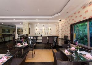 a dining room with tables and chairs in a restaurant at Parklane Hotel in Siem Reap