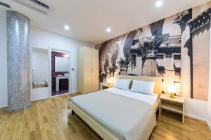 a bedroom with a bed and a painting on the wall at Split City Rooms in Split