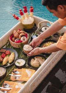 a table of food on a boat in the water at Furaveri Maldives - COMPLIMENTARY ROUND-TRIP SEAPLANE TRANSFER for two for a minimum of 5 nights or more from May 1st to October 31st, 2025 in Raa Atoll +37 photos